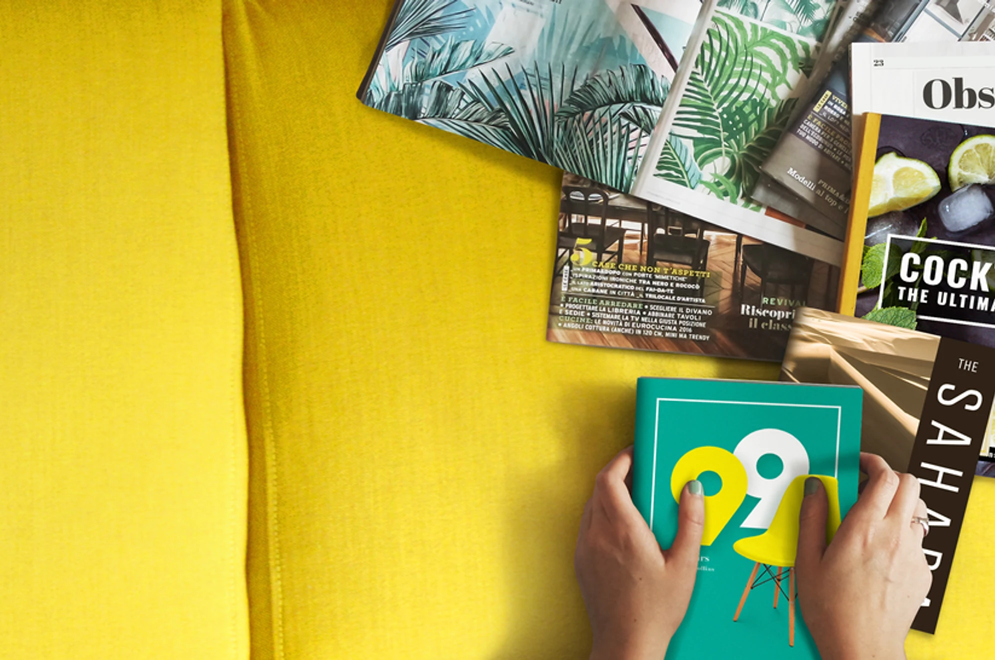 part of a yellow surface table with magazines and book